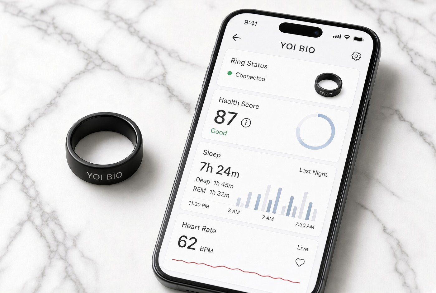 The YOI BIO Smart Ring next to a phone showing ring status, health score, sleep and heart rate in the Yoi Bio app